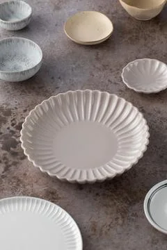 A variety of ceramic empty plates and bowls on the table. Kitchen, menu. 스톡 사진