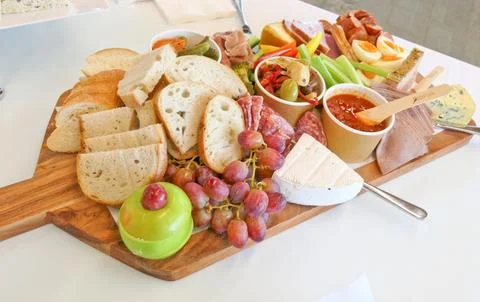 Variety of cheese bread biscuits ham salami cracker Stock Photos