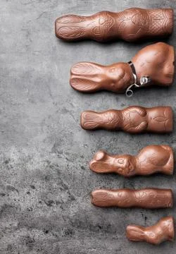 Variety of chocolate Easter bunnies on rustic background Stock Photos