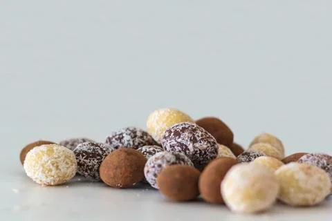 Variety of chocolate eggs on white table Stock Photos