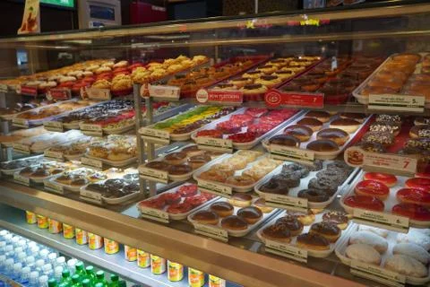 Variety of delicious donut in showcase on display at bakery cake shop Krispy  Stock Photos
