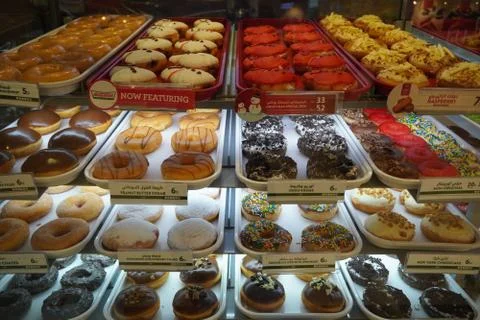 Variety of delicious donut in showcase on display at bakery cake shop Krispy  Stock Photos
