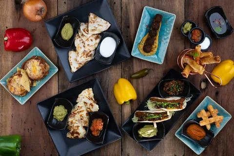 Variety of delicious starters isolated on rustic wooden table 스톡 사진