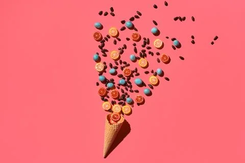 A variety of delicious sweets explode from the waffle cone, view from above Fotos Stock