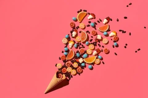 A variety of delicious sweets explode from the waffle cone, view from above Foto stock