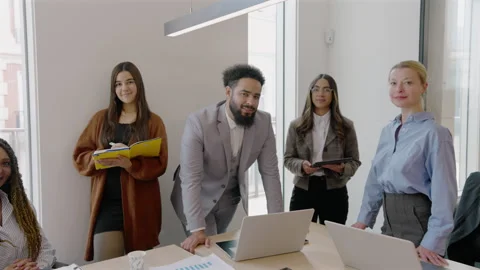 A variety of diverse professionals work together in a modern and dynamic office Video stock 305796713