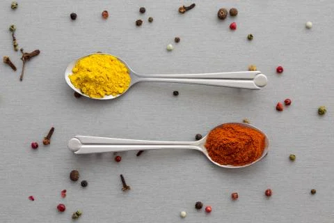 Variety of Eastern Spices in two Silver Spoon Stock Photos