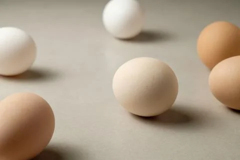 Variety of eggs on a simple surface showcasing natural colors and shapes Stock Photos