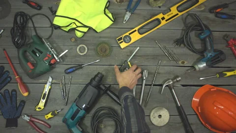 A variety of electro and hand tools and special clothing. Top view. Slow motion. Видео 121872126