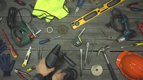 A variety of electro and hand tools and special clothing. Top view. Slow motion. Видео 121872139
