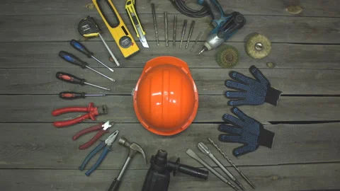 A variety of electro and hand tools, safety helmet and gloves. Top view. Видео 121872196