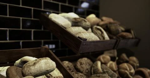 Variety of fresh baked bread displayed in a rustic bakery setting Stock Illustration