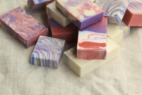 A variety of handmade soap in various designs on display Stock Photos