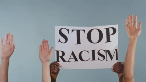 Variety of individuals display raised hands and signs demanding racial justice Stock Footage 324998025