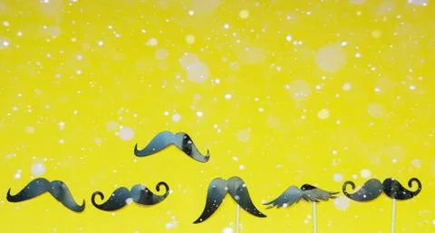 A variety of moustache, and snow on yellow background, abstract background Stock Photos