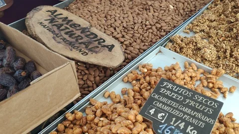 Variety of nuts and dried fruit on trading table. Open air marketplace Stock Footage 112633380
