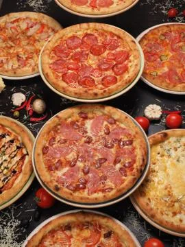 Variety of pizza on the table, top view Stock Photos