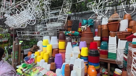 Variety of plastic pots in different sizes, shapes, and vibrant colors Stock Footage 319222899