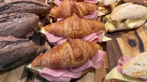 A variety of sandwiches with different breads and fillings on a board 動画素材 260786053