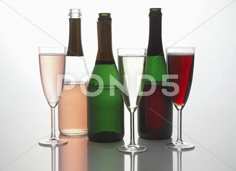 A Variety Of Sparkling Wine Bottles And Glasses Of Sparkling Wine