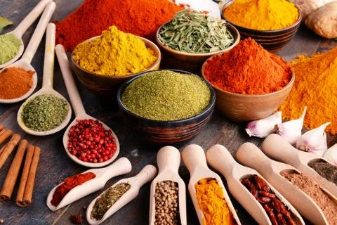 Variety of spices and herbs on kitchen table. Stock Photos