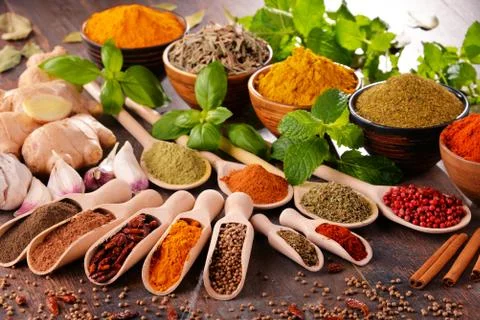 Variety of spices on kitchen table. Stock Photos