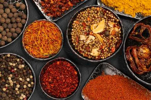 Variety of spices on kitchen table. Stock Photos