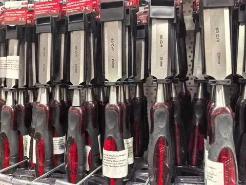 Variety of tools lined up in a hardware store during a busy shopping day Stock Photos