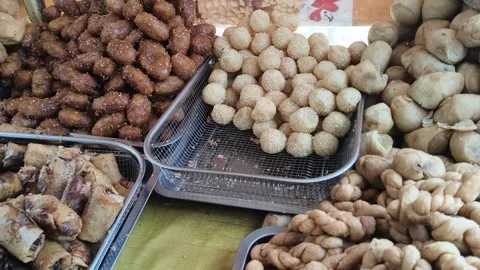 Variety of traditional fried snacks and street food on display Stock Footage 346485149