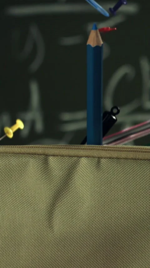Various accessories fall into the school pencil case. Filmed on a high-speed Stock Footage 335370777