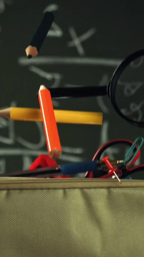 Various accessories fall into the school pencil case. Filmed on a high-speed Stock Footage 335375278