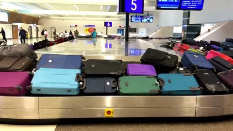 Various airport baggage claim carousel with colorful luggage laying in line.. Stock Footage 256743591