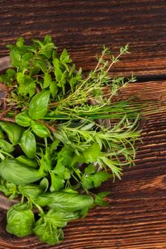 Various aromatic culinary herbs, rustic style. Stock Photos