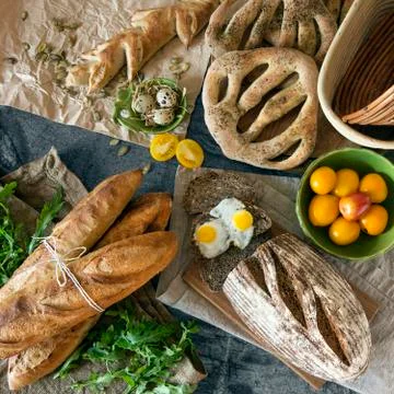Various artisan breads on the stone table Stock Photos