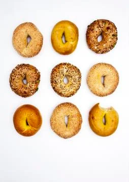 "various bagels, one with bite missing" Stock Photos