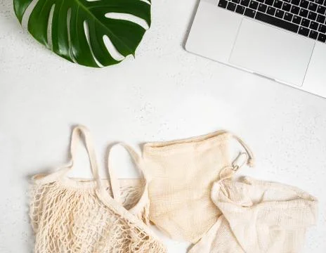 Various bags with drawstring, string bag and laptop flat lay Stock Photos