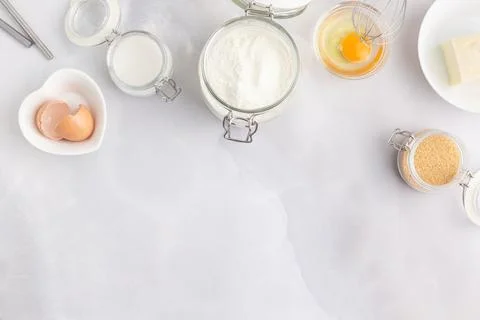 Various baking ingredients - flour, eggs, sugar, butter and kitchen utensils on Stock Photos