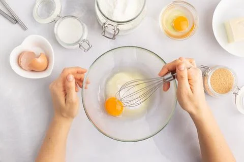 Various baking ingredients - flour, eggs, sugar, butter and kitchen utensils on Stock Photos