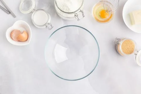 Various baking ingredients - flour, eggs, sugar, butter and kitchen utensils on Stock Photos