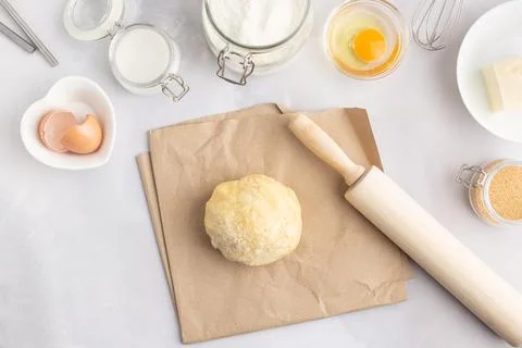 Various baking ingredients - flour, eggs, sugar, butter and kitchen utensils on Stock Photos