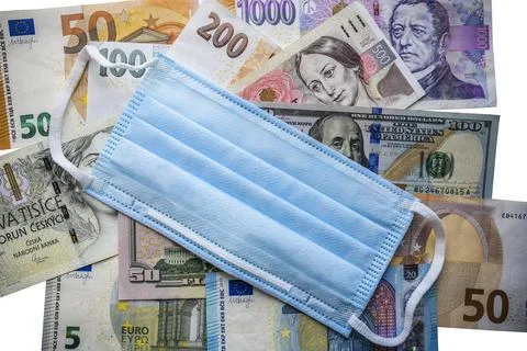 Various banknotes money on the table with protective medicine surgical mask over Stock Photos