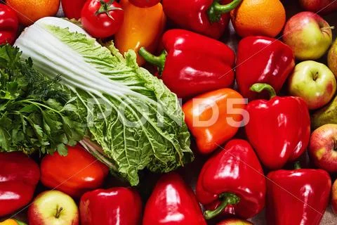 Various beautiful vegetables and fruit are scattered on a canvas Stock Photos