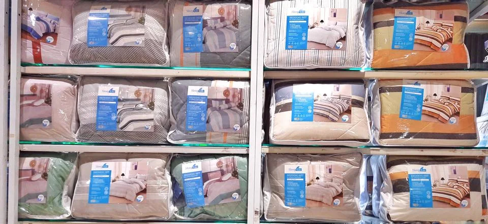 A various of bed sheets display on the shelf in store. Bedding Stock Photos