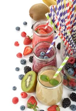 Various berry smoothies on a white background Stock Photos