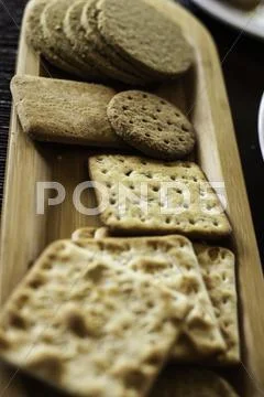 Various biscuits on a wooden plate Stock Photos