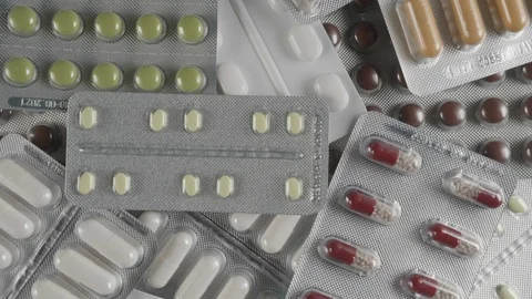 Various blister tablets rotating. Rotation background. Top view. 4K Video stock 124425852