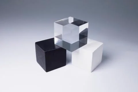 Various block shapes arranged in stack on gray background Stock Photos