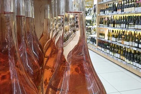 Various bottles of rose wine stand elegantly on display. The store features a Stock Photos