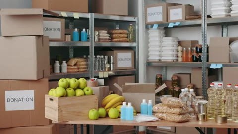 Various boxes of grocery standing on shelves at food bank Stock Footage 172144018