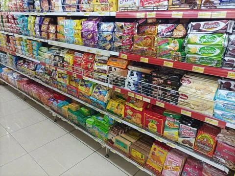 Various brands of biscuits and snacks on display Stock Photos